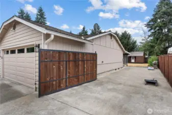 Side of the home, offering gate access, RV parking and hot tub hookups.