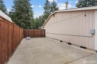 Side of the home, offering gate access, RV parking and hot tub hookups.