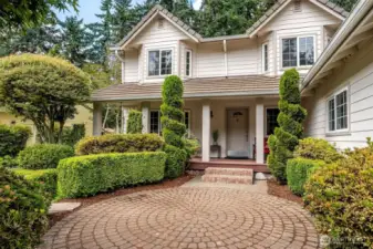 Amazing pavers and landscaping. Tile roof and covered porch.