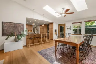 The dining room looks out to the backyard and benefits from vaulted ceilings, skylights and space for any occasion!