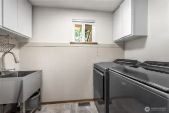 Laundry room is on the first floor, just inside from the garage and across the hall from the powder room.