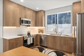 Thoughtfully designed kitchen boasts premium stainless appliances, custom cabinetry, and seamless modern finishes.