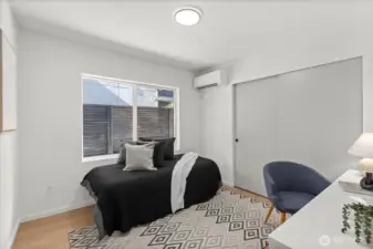 Versatile and serene, this lower-level bedroom offers ample light, split-system A/C, and generous closet space.