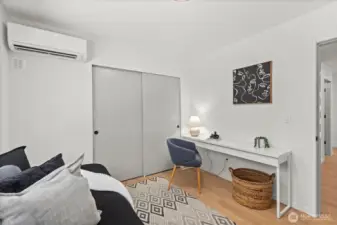 This versatile bedroom features a dedicated workspace, oversized closet, and ductless mini-split for year-round comfort.
