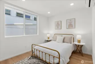This bright third bedroom features peaceful views, soft natural light, and a minimalist palette perfect for rest or productivity.