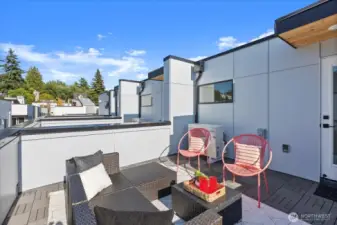 Enjoy indoor-outdoor living with this spacious rooftop deck framed by cityscapes and tree-lined views in every direction.
