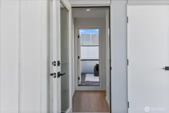 A sleek transition space leads directly to the private rooftop deck, creating seamless indoor-outdoor flow.