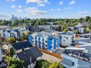 Modern townhomes stand out with bold blue accents and a central location surrounded by vibrant urban growth.