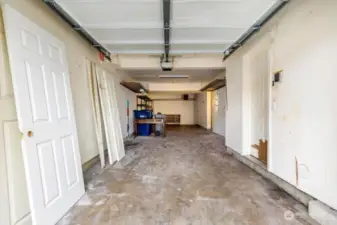 Two car tandem garage with an additional storage area off to the right.