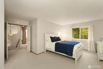 Another shot of primary bedroom with double doors.