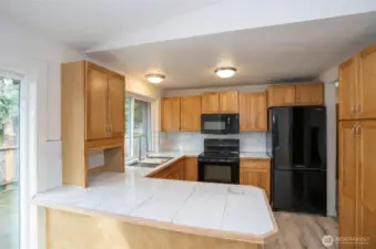 Kitchen highlights include gorgeous cabinets, countertops, and a welcoming eating bar for meals and conversation.