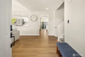 Entrance to home into foyer & open living space.