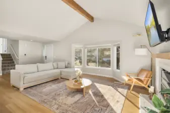 Spacious living area with large windows allowing naturall light to fill the space.