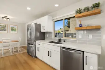 Chef's kitchen featuring SS appliances, quartz counters & oversized island.