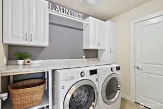 Floor to ceiling cabinets and a folding shelf. LG washer and LG electric dryer stay with the home.
