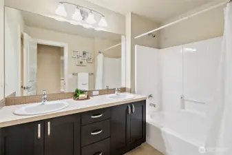 Full bath located upstairs with double sinks for functionality.