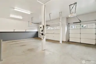 Three car garage equipped with a EV charger and updated garage doors.