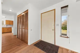 Entry, hallway leads to garage and kitchen.
