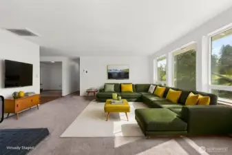 Large living area with a woodstove for cozy nights and three large windows allowing so much light into the area.