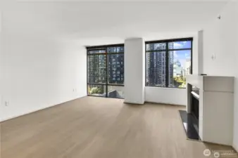 A large, open layout with fresh light-toned flooring creates a warm, modern atmosphere. The living room easily accommodates both lounging and dining areas.