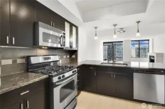Rich espresso cabinetry paired with sleek stainless-steel appliances.