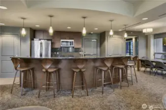 The built-in kitchen with granite counters, bar seating, and stainless-steel appliances makes entertaining easy and convenient.