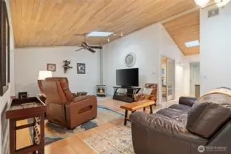 Living room w/gas stove, entry hall on right