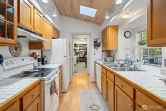 Galley kitchen toward pantry to office/craft room.