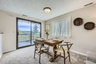 Large dining area with slider to upper deck with lake view.