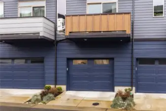 A closer view of the townhome's garage and balcony