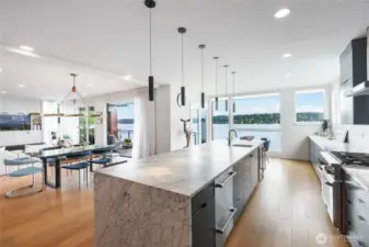 Beautifully updated kitchen with Large center island, walls of custom cabinetry, shelving and storage and mutliple prep areas.