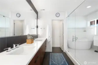 Primary bedroom suite bathroom, dual sinks, oversized shower with soaking tub.