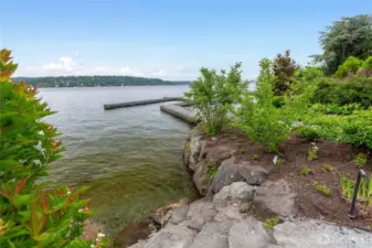 Low bank waterfront with stone steps into the lake. Irrigation and low voltage lighting. Private dock.
