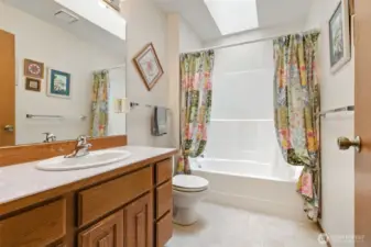 Full bathroom featuring skylight