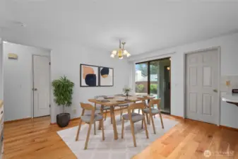 Virtually staged dining space with door to fenced backyard
