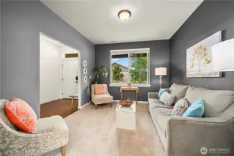 View of the first living space from the formal dining room. On the left is the front entrance to the home.