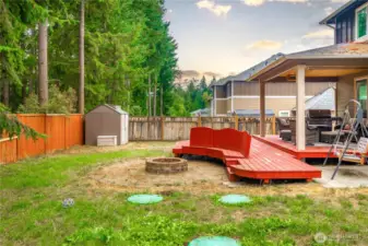 Outdoor living dream! Complete with a fire pit and seating built into the side of the deck!