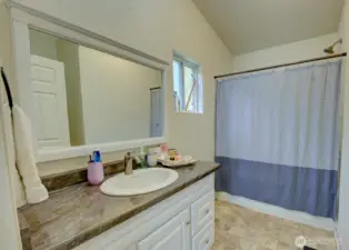 En-Suite full bathroom with oversized vanity, large mirror, window and tub/shower combo