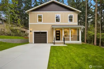 This is a custom-designed, contemporary home featuring a prominent covered front porch, offering a welcoming and stylish entry.