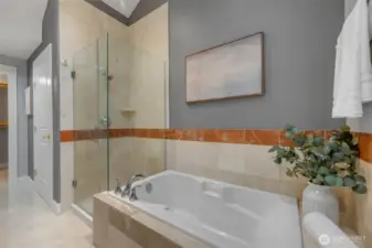 Large soaking tub and radiant in-floor heating make the primary bath spa like