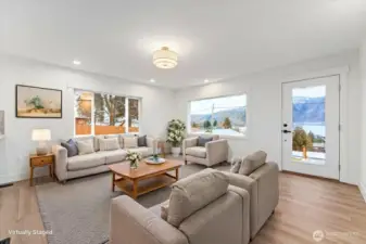 Virtually Staged - The living room features expansive windows that flood the space with natural light while framing the views from every angle—an inviting place to relax, gather, and create lasting memories with loved ones.