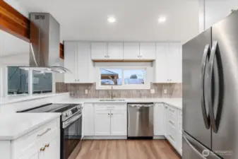 The kitchen has been completely remodeled with new stainless steel appliances, new cabinetry, updated countertops, and a stylish backsplash—bright, clean, and modern.
