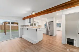 A sliding glass door off the dining and kitchen area enhances indoor-outdoor living, making it ideal for entertaining and everyday use of the kitchen. From this space, a separate door leads to the fully finished basement, featuring an additional living room, bedroom, and full bathroom.