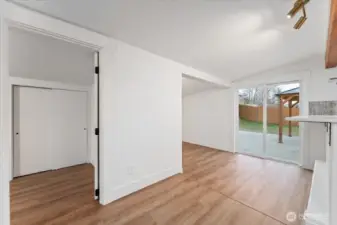 The second bedroom on the main floor is located just off the kitchen and dining area, to the left. To the right, you’ll find the dining area.