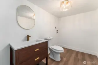 Next to the second bedroom is a half bathroom, conveniently equipped with new washer and dryer hookups for added ease and functionality.