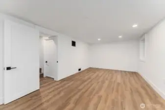 It includes a spacious bedroom that could also serve as an additional living area, complete with the same modern updates and stylish finishes found throughout the home.