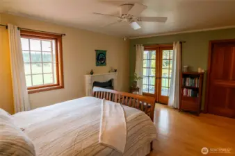 Main house floor 2 primary bedroom with ensuite fireplace, private deck overlooking northern pastures, walk-in closet