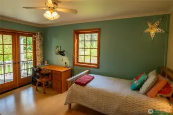 Main house floor 2 second bedroom with walk-in closet, private deck overlooking the garden