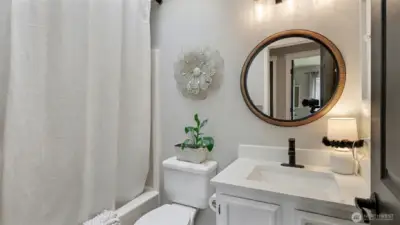 Guest bath offers newer vanity with quartz counters