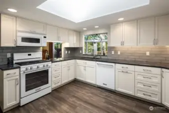Kitchen with breakfast nook and opening to sunroom